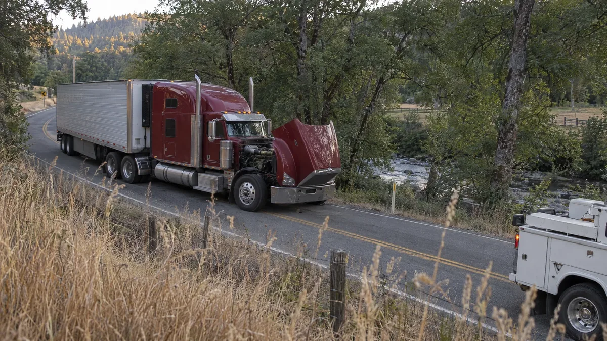 Dark red commercial semi stopped naturally on a remote Southern Oregon rural roadside repair call